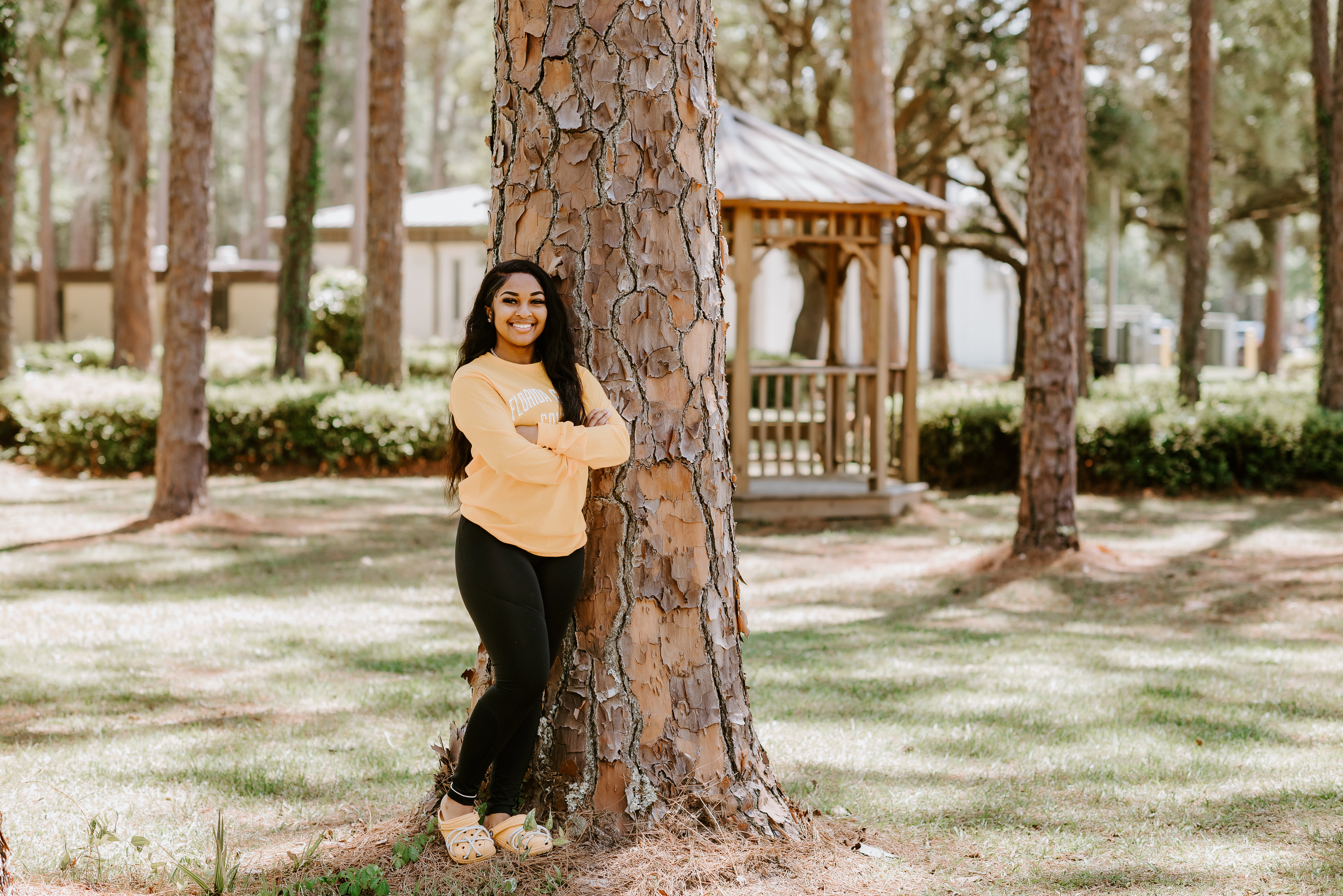 student life Student on campus in front of tree