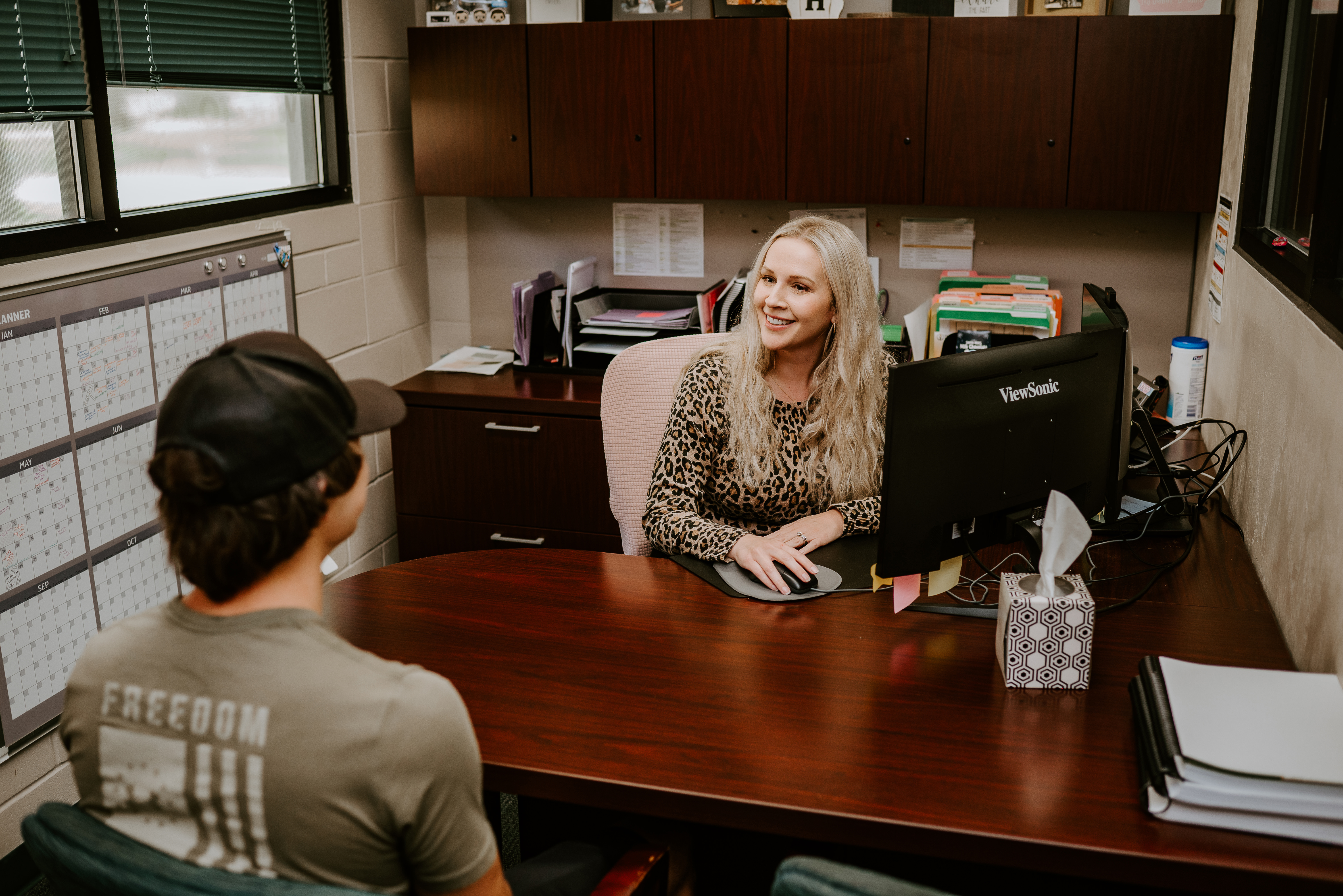 Student success coach and student meeting in office