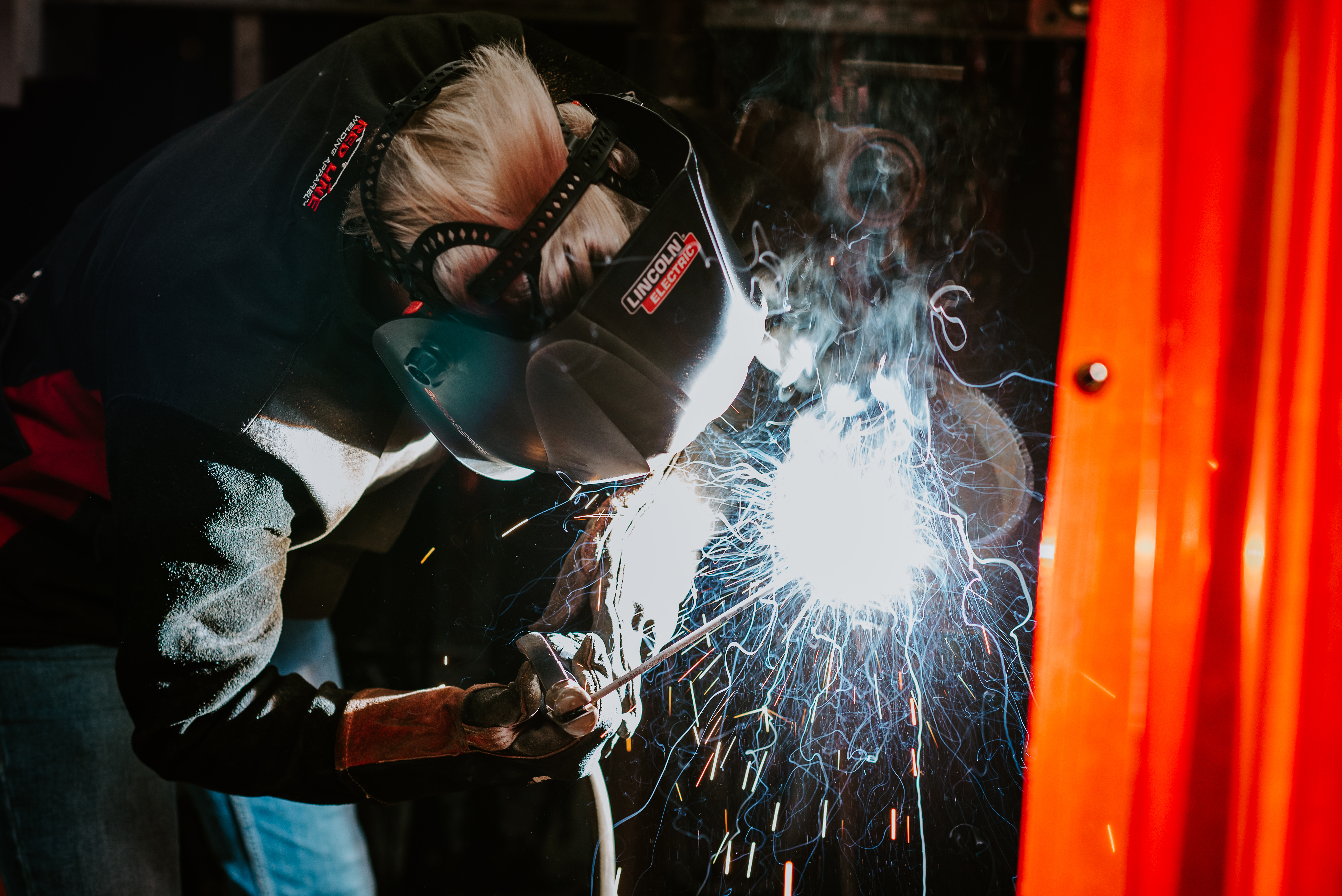 Student completing a weld in welding lab