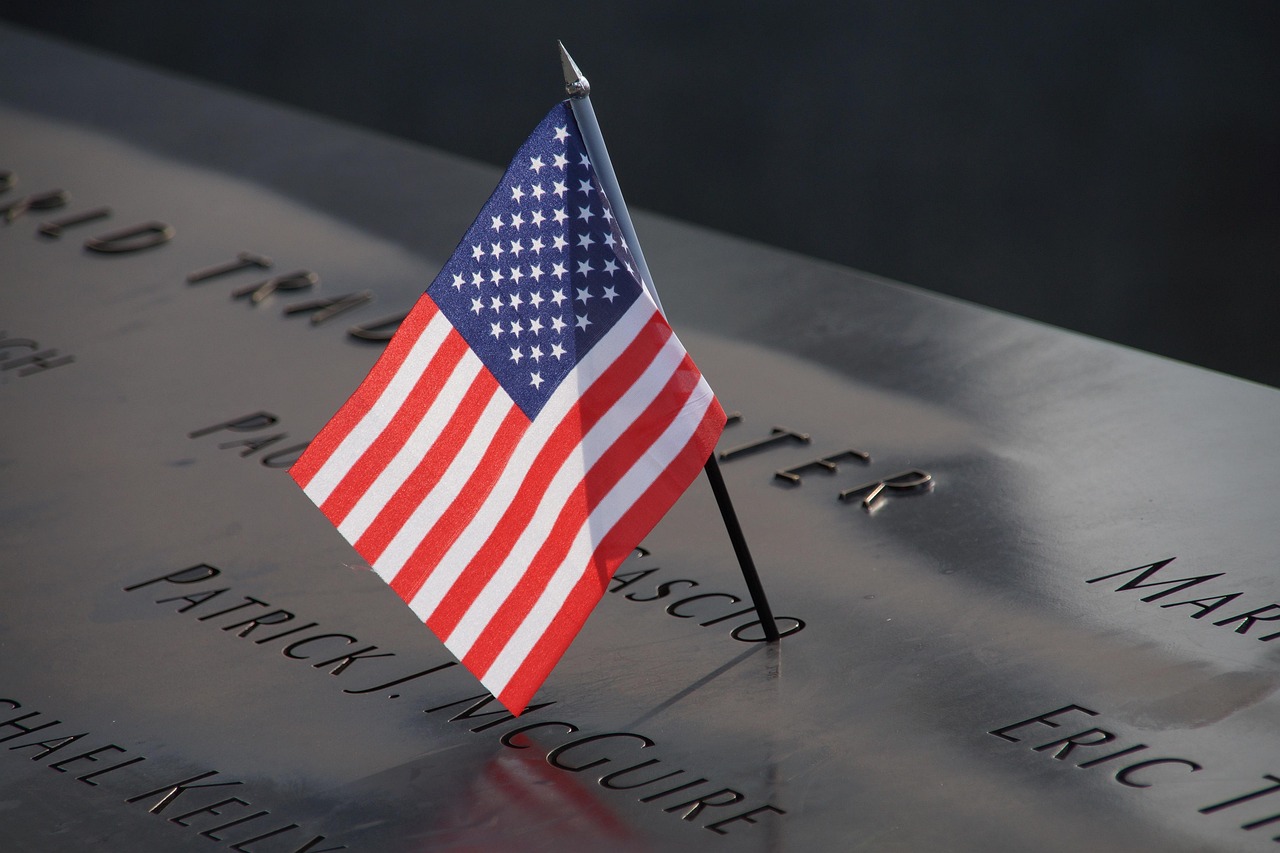 Small American flag placed in name on 9/11 Memorial in New York.