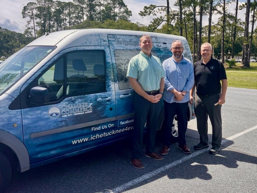 Chamber and college representatives stand with donated van.